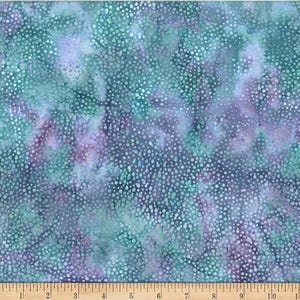 May include: A blue and green fabric with a white polka dot pattern. The fabric has a tie-dye effect with shades of purple and blue.