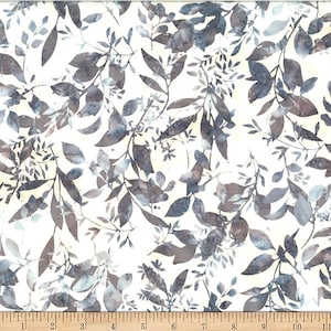 May include: White fabric with a repeating pattern of gray and blue leaves. The fabric is measured with a ruler in inches.