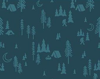 May include: Dark teal fabric featuring a repeating pattern of teal trees, tents, crescent moons, and a Bigfoot silhouette. The pattern is set against a dark teal background. The ruler shows measurements in inches.