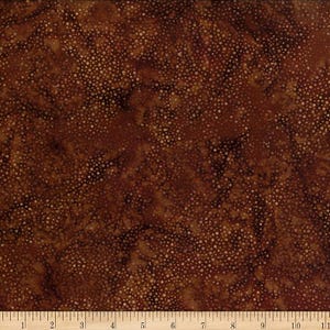 May include: Close-up of a brown fabric with a mottled pattern and small white dots. The fabric has a textured appearance and a dark, earthy color palette. The fabric is suitable for quilting, sewing, or other craft projects.