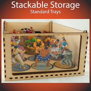 May include: A wooden box with a clear plastic insert, designed for stacking. The box is filled with small plastic figurines, each on a round base. The box has the text "Stackable Storage Standard Trays" printed on the top.