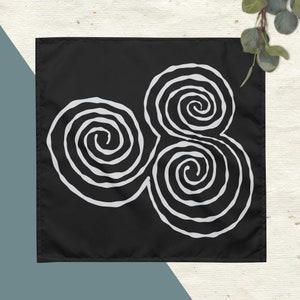 May include: Black fabric square with a white design of three interlocking spirals.