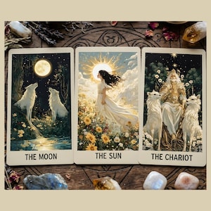 May include: Three tarot cards with illustrations of The Moon, The Sun, and The Chariot. The Moon card shows two wolves howling at a full moon. The Sun card depicts a woman in a white dress. The Chariot card shows a king with two white wolves.
