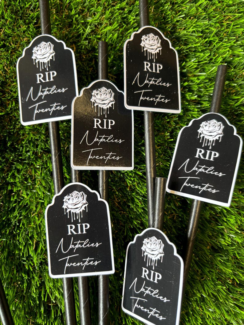 May include: Six black and white paper straws with a tombstone-shaped sticker that says "RIP Natalies Twenties". Each sticker has a black rose with dripping water.