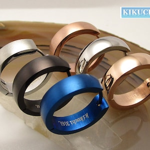 Può includere: Cinque orecchini a cerchio in diversi colori, tra cui argento, nero, blu, oro rosa e oro. Gli orecchini sono tutti della stessa dimensione e hanno un design semplice ed elegante. Gli orecchini sono incisi con la parola "Kikuchi 316L".