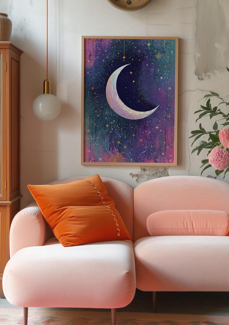 May include: A framed print of a crescent moon with a gold outline against a dark blue background with gold stars. The background is a watercolour wash of pink, purple, and green.