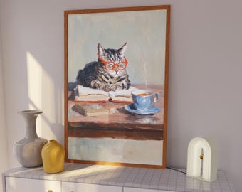 May include: A framed painting depicts a tabby cat wearing orange glasses, reading a book at a table with a cup of tea. The artwork has a warm color palette and a vintage aesthetic. The painting is displayed above a white cabinet with decorative vases and a modern lamp.