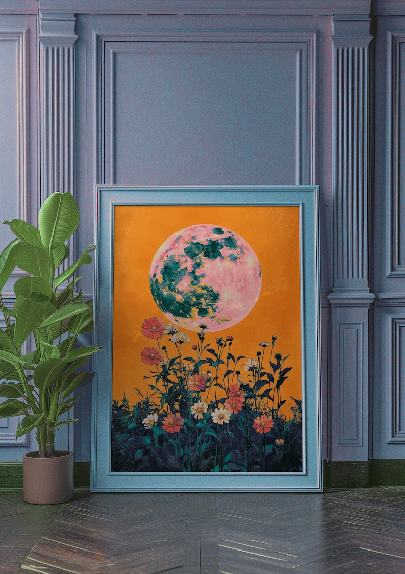 May include: A framed print of a pink and green moon with a yellow background and a field of flowers in the foreground.