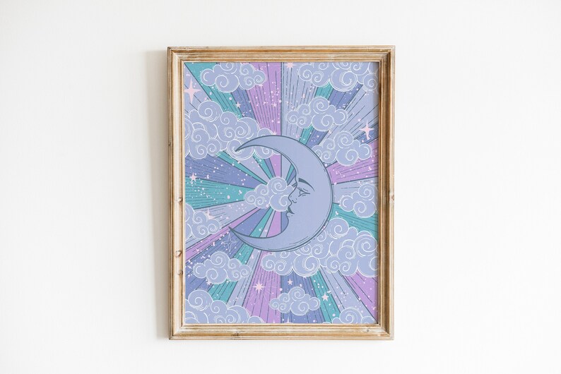 May include: A framed print with a crescent moon with a face in the center. The moon is surrounded by a colorful background of clouds, stars, and rays of light in shades of purple, pink, blue, and green.