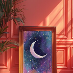 May include: A framed painting depicting a crescent moon in a starry night sky. The moon is white with a gold outline and is set against a dark blue background with purple and pink hues. The painting is surrounded by a gold frame.