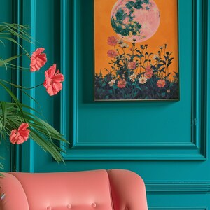 May include: A framed print with a large, pink and green moon over a field of orange and white flowers on a yellow background.