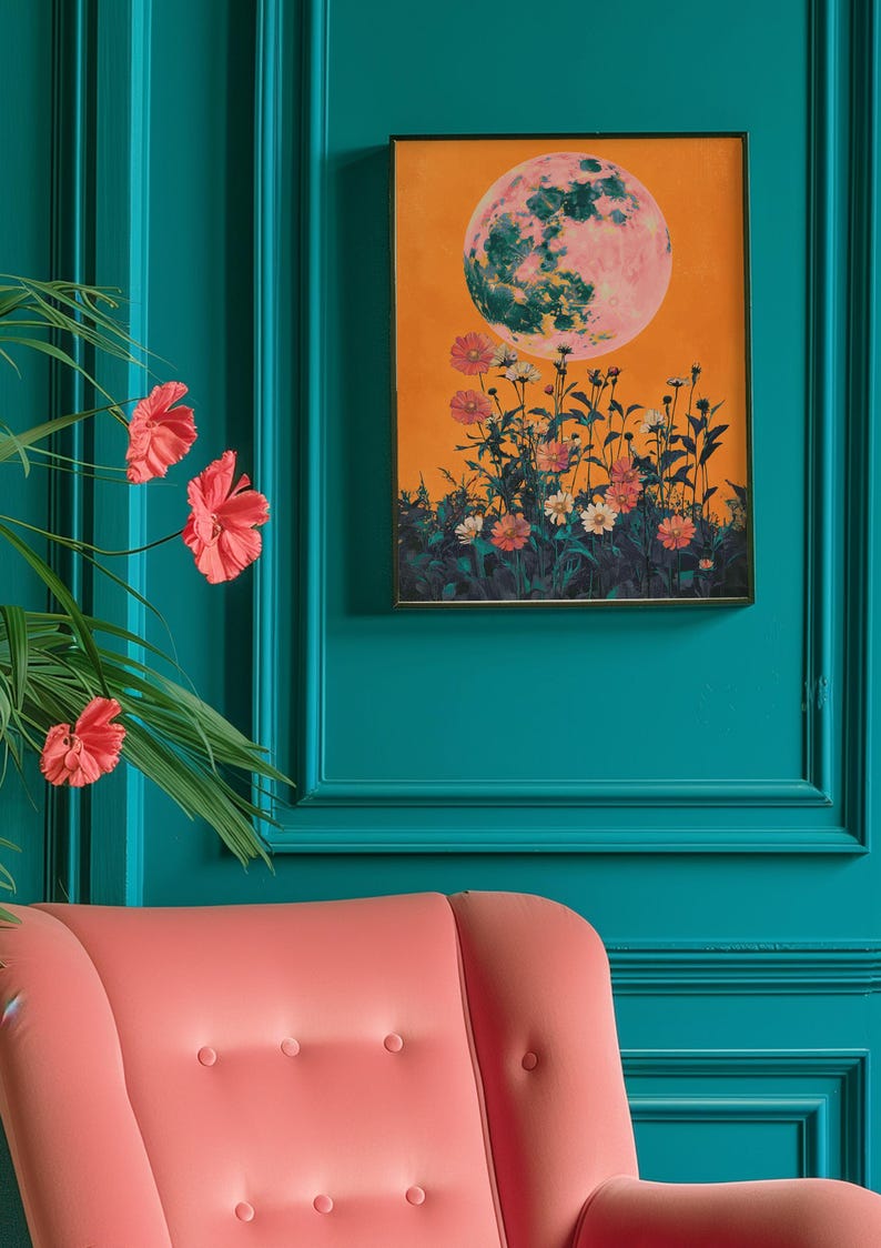 May include: A framed print with a large, pink and green moon over a field of orange and white flowers on a yellow background.