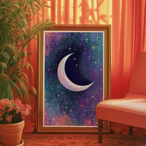 May include: A framed print of a crescent moon with a white and gold outline against a dark blue and purple starry sky. The background has a watercolour effect with gold glitter accents.