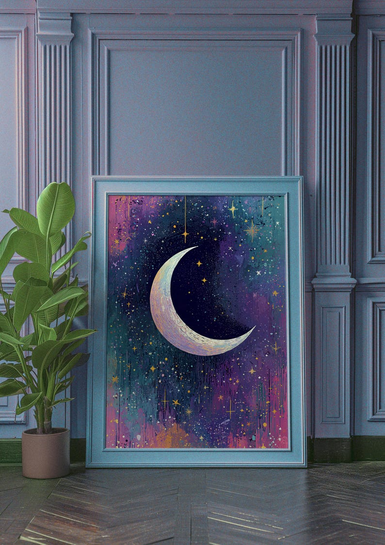 May include: A framed print of a crescent moon with a white, iridescent finish against a dark blue background with gold stars and a purple and pink nebula.