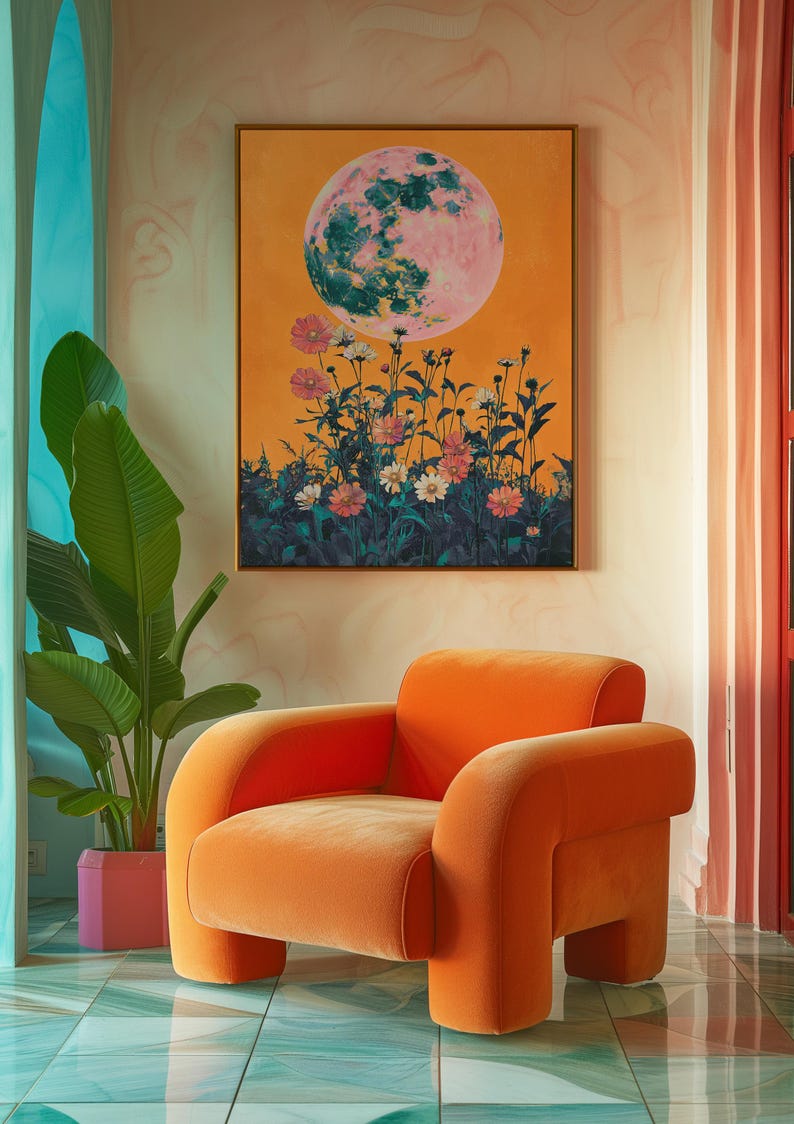 May include: A bright orange velvet armchair with rounded edges sits in a room with a large painting of a pink moon and flowers. The room has a teal and white tiled floor.