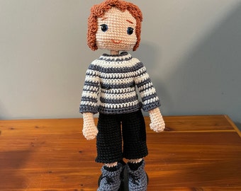 10 " tall crochet doll with auburn hair and removable clothing and shoes.