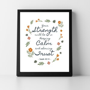 May include: A framed print with the text "Your strength will be in keeping calm and showing trust" surrounded by floral illustrations. The print is in a black frame and features the Bible verse Isaiah 30:15.