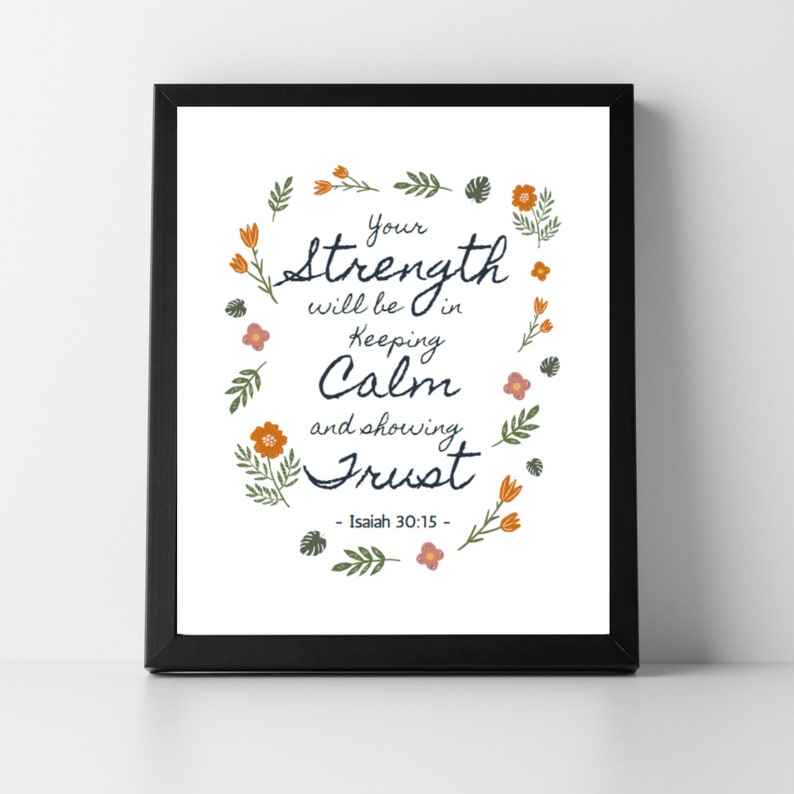 May include: A framed print with the text "Your strength will be in keeping calm and showing trust" surrounded by floral illustrations. The print is in a black frame and features the Bible verse Isaiah 30:15.