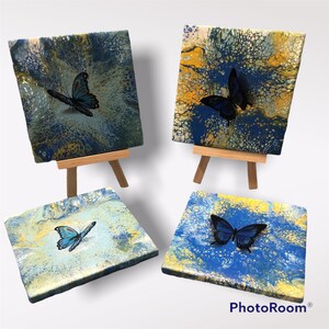 A set of 4 butterfly themed ceramic coasters.