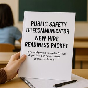 May include: A white booklet titled "PUBLIC SAFETY TELECOMMUNICATOR NEW HIRE READINESS PACKET" is held in a person's hand. The booklet includes the text "A general preparation guide for new dispatchers and public safety telecommunicators."