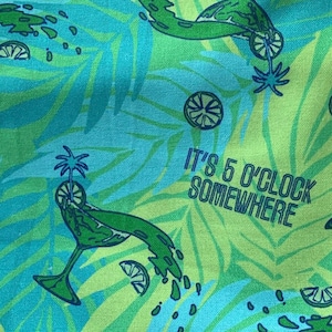 May include: A green and blue tropical print fabric with the text "It's 5 o'clock somewhere" and a repeated pattern of green palm leaves, lime slices, and a martini glass with a lime garnish.