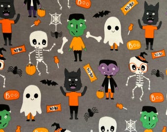 May include: A gray fabric with a Halloween-themed pattern featuring various characters like skeletons, ghosts, vampires, werewolves, and Frankenstein's monster. The fabric also includes bats, spiders, candy corn, and the words "Boo" and "Trick-or-Treat".