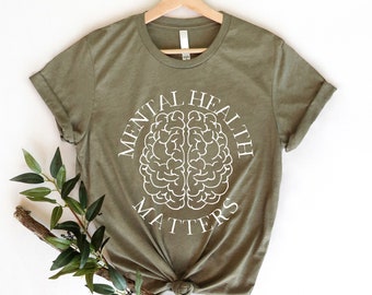 May include: A green t-shirt with a white graphic of a brain and the text "Mental Health Matters".