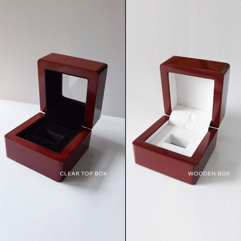 May include: Two open wooden boxes with a glossy, reddish-brown finish. One box has a clear top and a black interior, while the other has a white interior. The text "CLEAR TOP BOX" and "WOODEN BOX" are visible.