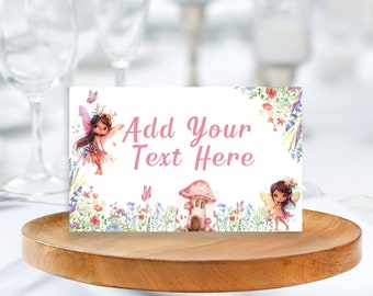 May include: A white card with a pink floral border and two fairies. The card has the text "Add Your Text Here" in pink. The card is sitting on a wooden coaster.