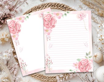 May include: Two sheets of stationery paper featuring watercolor illustrations of pink flowers, green leaves, and small butterflies. One sheet is blank, while the other contains horizontal lines for writing. The floral designs are in the corners.