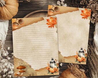 May include: Two sheets of stationery paper with a vintage parchment texture. One sheet features horizontal lines, while the other is blank. Both are decorated with autumn-themed illustrations including orange maple leaves, acorns, mushrooms, and lanterns.