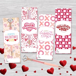May include: Valentine's Day gift set featuring pens with diamond tops and pink barrels, alongside matching bookmarks. The bookmarks display heart patterns, the text "Happy Valentine's Day", and space for "To: From:" messages.