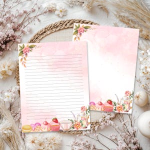 May include: Two sheets of stationery paper with a soft pink watercolor wash background. One sheet features horizontal black lines for writing, while both sheets are decorated with illustrations of pink roses, teapots, teacups, and cupcakes.