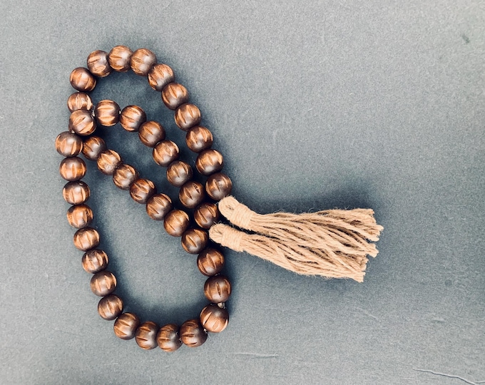 Rustic Espresso Wood Bead Strand with Carved Details and Earthy Jute Tassels