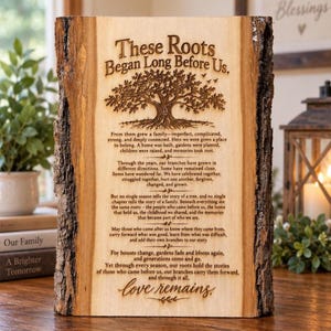 May include: A rectangular wooden plaque with natural bark edges featuring a laser-engraved tree illustration and the text: These Roots Began Long Before Us. The plaque includes a long poem about family history and concludes with the words love remains.