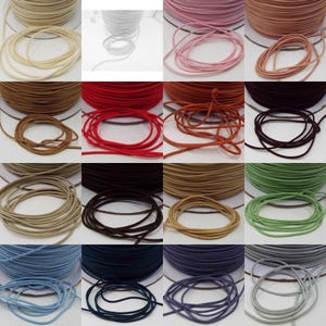 May include: Assortment of 12 colours of elastic cord, each colour is wound in a coil. The colours are: beige, brown, red, orange, tan, green, light blue, dark blue, purple, grey, white, and pink.