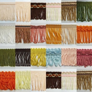 May include: A collection of 20 different colours of fringe trim with various patterns and textures. The fringe is approximately 1 inch wide and has a variety of lengths.