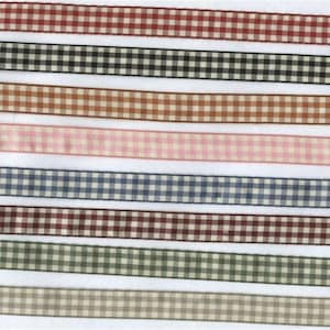 May include: Assortment of eight gingham ribbon trims in various colours, including red, black, brown, pink, blue, burgundy, green, and beige.