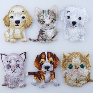 May include: Six embroidered iron-on patches featuring cute cartoon animals. The patches include a brown and white dog, a grey and white cat, a white dog, a grey cat, a brown and white dog, and a brown and white cat.