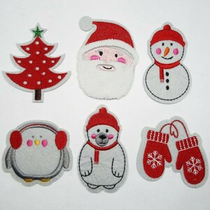 May include: Six felt Christmas-themed appliques: a red and white Christmas tree, Santa Claus, a snowman, a penguin with red earmuffs, a polar bear wearing a red hat and scarf, and a pair of red mittens with snowflakes.