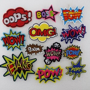 May include: A set of 12 colourful embroidered iron-on patches featuring various comic book style words like "POW!" "BOOM!" and "OMG!"