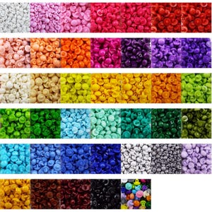 May include: Assortment of colourful plastic buttons in various shapes and sizes. The buttons are arranged in rows by colour, including white, pink, orange, red, purple, blue, green, light blue, dark blue, grey, brown, black, and multi-coloured.