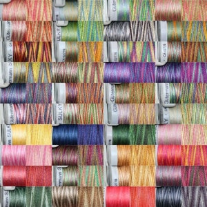May include: A collection of colourful embroidery floss spools in various shades of red, orange, yellow, green, blue, purple, pink, brown, and black. The spools are arranged in a grid pattern and labelled with the brand names "Sulky", "Gütermann", and "C.A. Gütermann".
