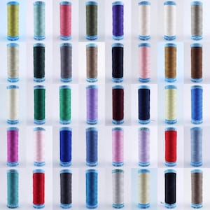 May include: A collection of 36 spools of thread in various colours, including red, blue, green, pink, white, and black. Each spool is labelled with the brand name "Gutermann" and a colour code.