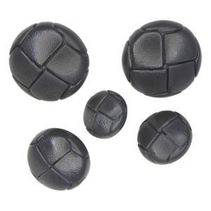 May include: Five black buttons with a textured, woven design. The buttons are round and have a slightly raised surface.