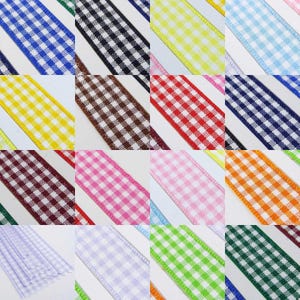 May include: Assortment of gingham ribbon in various colours, including blue, black, yellow, brown, red, pink, white, orange, green, and purple. The ribbon is 1/2 inch wide and has a checkered pattern.