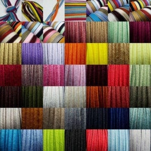 May include: Assortment of 40 colours of 1/4 inch wide, cord, elastic, or ribbon. The cord is textured and has a herringbone pattern. The colours include red, blue, green, yellow, orange, purple, pink, brown, black, white, and grey.