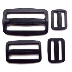 May include: Four black plastic slider buckles. Two are rectangular with a single slot, one is rectangular with two slots, and one is curved with a single slot.