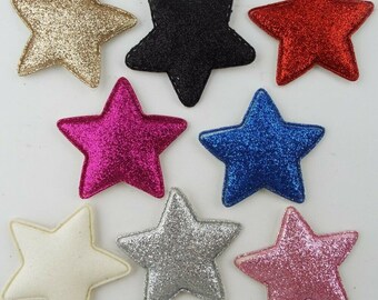 May include: Eight glitter star shapes in various colors, including gold, black, red, pink, white, silver, blue, and fuchsia. The stars are made of felt and have a 3D effect.