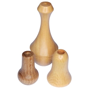 May include: Three wooden finials in different shapes and sizes. The finials are made of light brown wood and have a smooth finish.